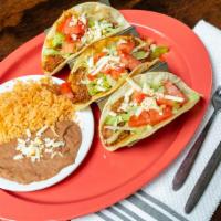 Tacos · Three tacos filled with your choice, Beef, Chicken, Pork, Cheese or Chorizo topped with fres...