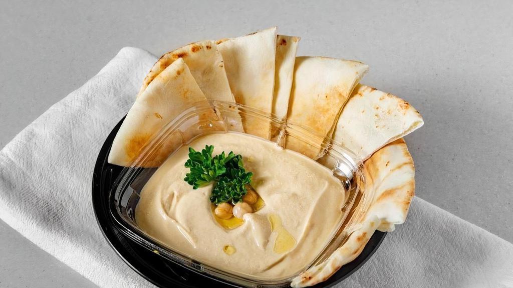 Hummus W/ Pita Bread · A famous creamy dip made from scratch using chickpeas, extra virgin olive oil, lemon juice, garlic, tahini. Served with our special thin pita bread.