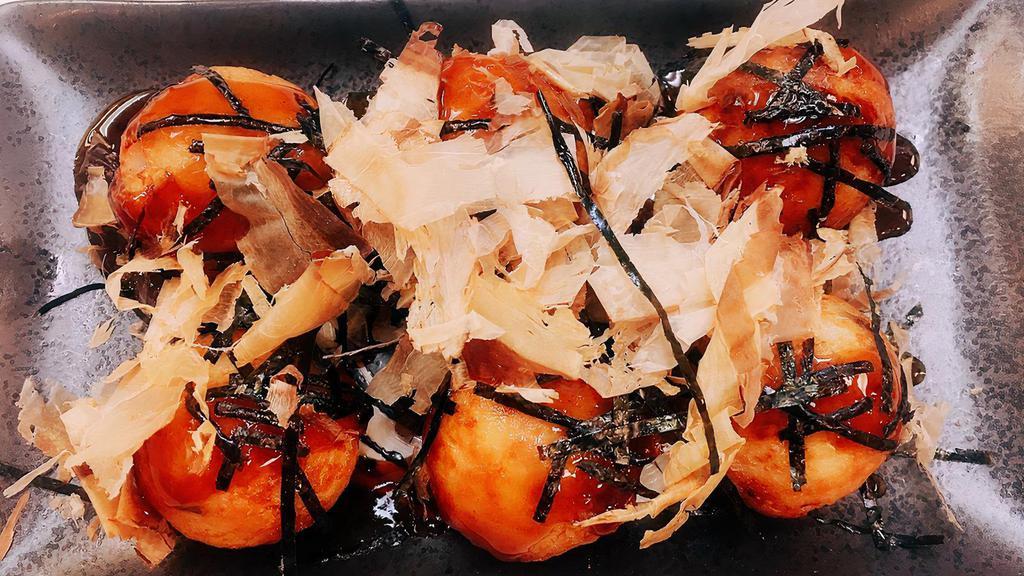Takoyaki · Fried octopus balls topped with bonito flakes and shredded nori.