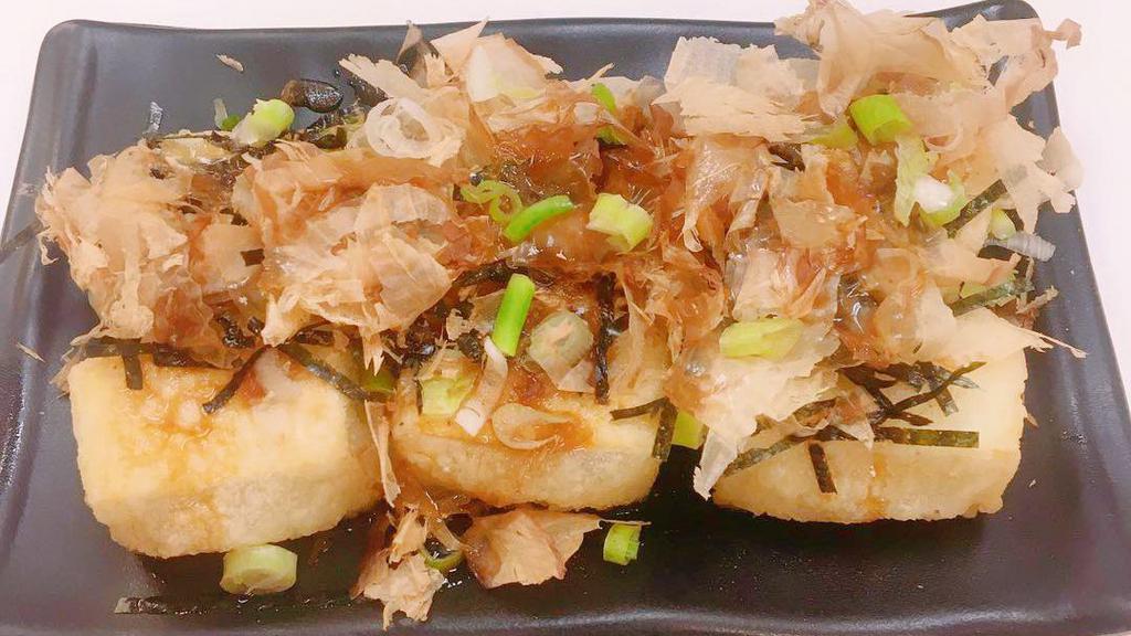 Agedashi Tofu · Crispy deep fried tofu topped with scallions, bonito flakes, and shredded nori in savory dashi sauce.