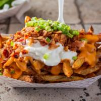 Loaded Fries · Topped with Merkt's cheddar cheese, bacon, green onions and sour cream.