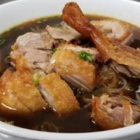 Duck Noodle Soup · A dark broth with bean sprout, scallion, spinach and rice noodles.
