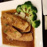 Garlic & Pepper Fish · Crispy fish topped with garlic and black pepper sauce served with steamed vegetables.