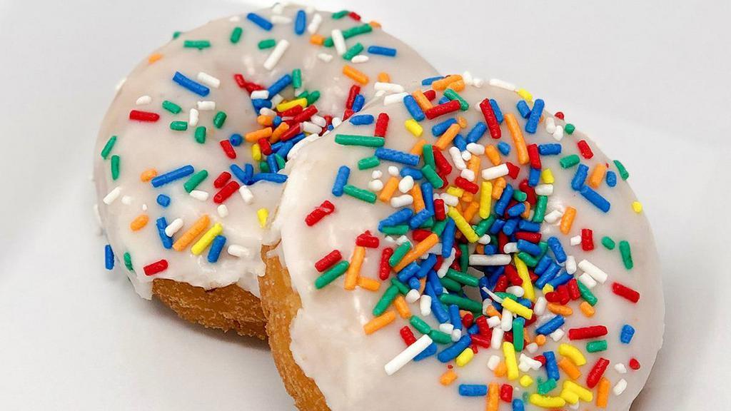 Vanilla Sprinkle Cake Donut · Our white cake donut with white glaze and seasonal colored sprinkles. Kids love these!