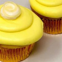 Lemon Drop Cupcake · Lemon cupcake topped with lemon icing a dollop of buttercream and a swirl of lemon filling