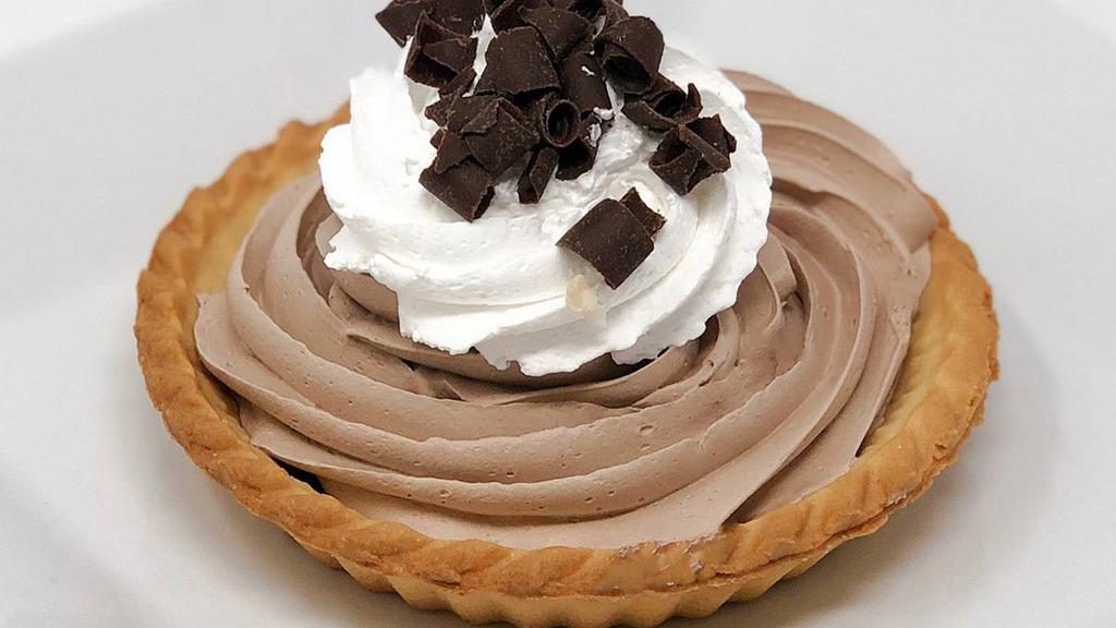 Chocolate Mousse Tart · A small pie shell filled with chocolate mousse and topped with whipped cream.