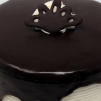 Tuxedo Dessert Cake · Chocolate cake with white buttercream filling and icing with ganache waterfall on top, also ...
