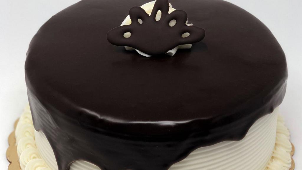 Tuxedo Dessert Cake · Chocolate cake with white buttercream filling and icing with ganache waterfall on top, also available in a 6