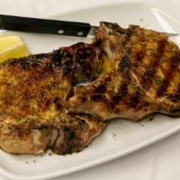 Pork Chops · Bone in pork chop finished with our special herb oil. Served with your choice of two sides. ...