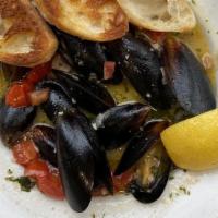 Mussels · Pei mussels, white wine, crispy pancetta, tomato, herb butter, baguette.