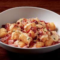Cheese And Bacon Tots · crispy tots, Paul's signature wahl sauce, pickled red onion, bacon, cheese sauce & parmesan ...