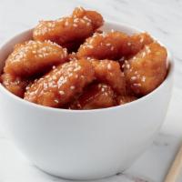 Sesame Chicken  · Crispy, tempura chicken tossed in a sweet and tangy sauce, garnished with sesame seeds. 1050...