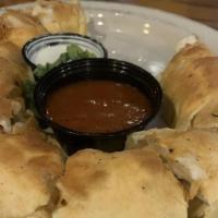 Bones · Fresh hand rolled pizza dough stuffed with mozzarella and baked to perfection. Served with m...