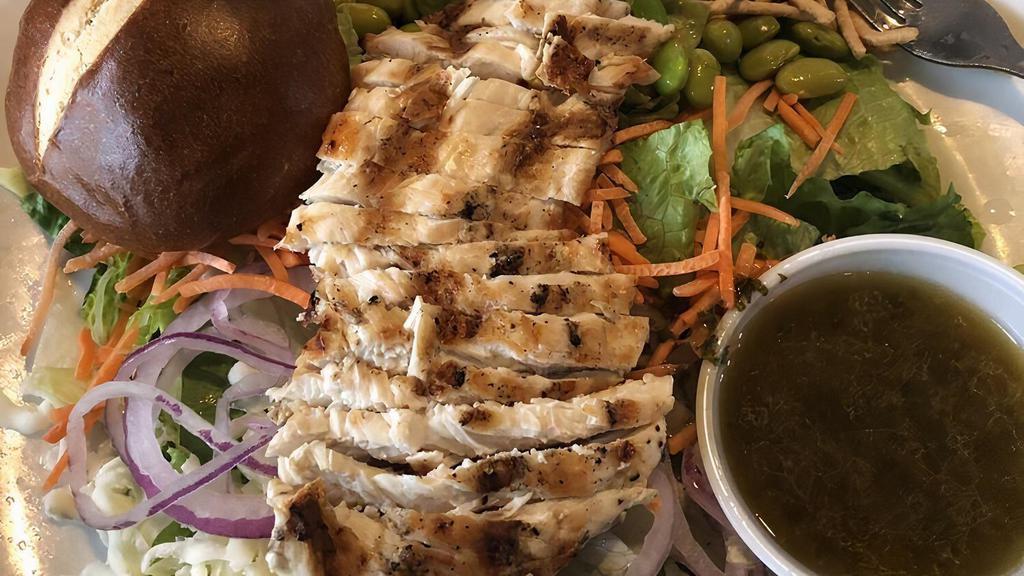Asian Chicken Salad · A blend of romaine and iceberg lettuce topped with crunchy noodles, edamame, carrots, mozzarella cheese, red onions, and grilled chicken. Served with miso vinaigrette.