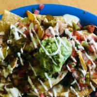 Nachos · Corn tortillas, refried beans, white queso with green chilis, pico de gallo, sour cream, pic...
