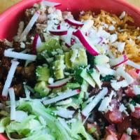 Taco Bowl · Shredded lettuce, refried beans, rice, pico de gallo, topped with radish, avocado, queso fre...