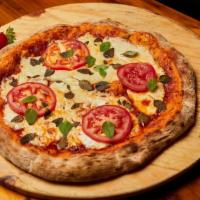 Margherita Pizza · Hand rolled pizza dough topped with a layer of
Roma tomatoes and fresh mozzarella baked to
p...