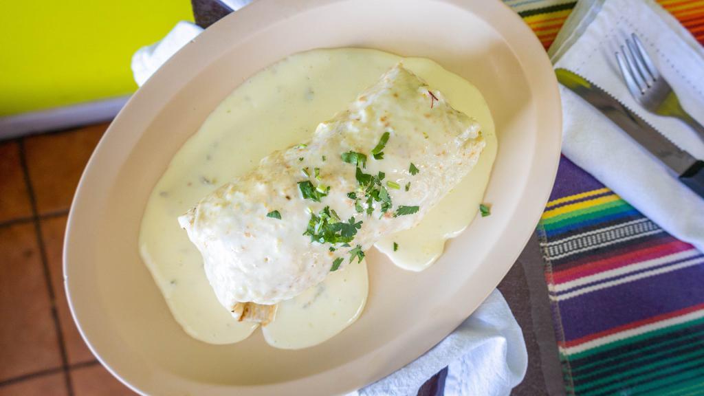 Suizo / Swiss Burrito · Our delicious burrito covered in our home made cheese dip