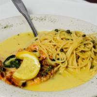 Grilled Salmon Limone · Salmon filet topped with capers and lemon butter sauce, served with spaghetti.
