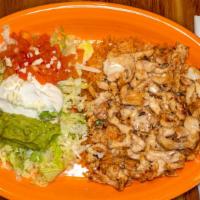 Arroz Con Pollo · Grilled chicken strips over a bed of rice covered with melted cheese. Served with guacamole ...