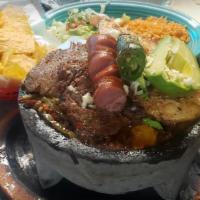 Andres Molcajete · Pork, steak, chicken, shrimp and chorizo, grilled with squash and Mexican onions, marinated ...