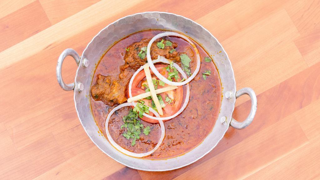 Goat Karhai · Deep marinated goat chunks on the bone, flash fried fresh with our thick sliced vegetable karhai curry sauce.