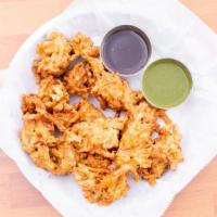 Pakoras · Vegan. Sliced onions, green chilies and cilantro mixed in a batter and fried to crispy puffs...