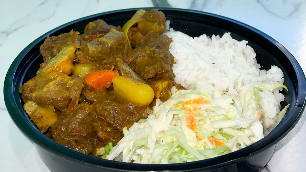 Curry Goat Bowl · Curry Goat cooked in an authentic Jamaican Curry Sauce. Seasoned with Blended Herbs and Spices. Served with Coconut Rice & Beans /or Vegetable White Rice, And Fresh Steamed Sautéed Veggies /or Coleslaw.