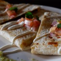 Steak Quesadilla · Marinated steak, filled with peppers and onions, topped with cheese. Served with crema, sals...