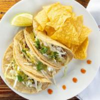 Steak Tacos  · 3 Asian inspired marinated steak tacos with sautéed onions, topped with slaw, cotija cheese,...
