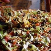 Taco Pizza · Large pizza with taco seasoned marinara base, our homemade taco beef topped with lettuce, pi...