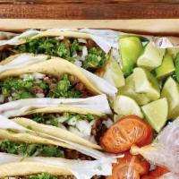 Classic Box · 10 tacos with choice of meat topped with cilantro and onions. Lots of salsa verde and roja, ...