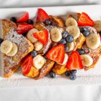 Signature French Toast · Brioche French toast, strawberries, blueberries, bananas.