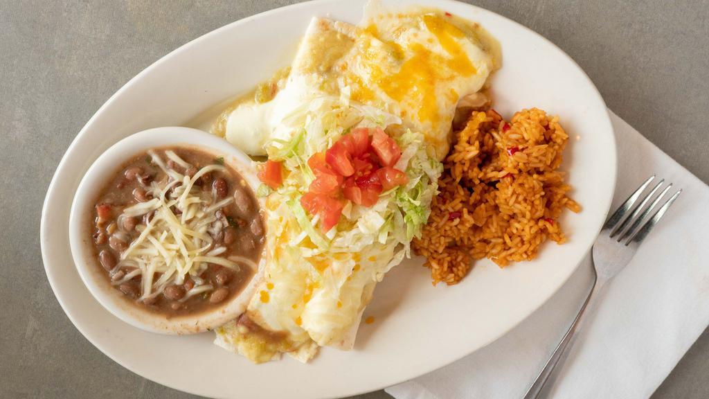 Sour Cream Chicken Enchiladas · Two flour tortillas filled with sour cream sauce and fajita chicken and topped with mild green chile, sour cream sauce, and a combination of jack and cheddar cheeses. Garnished with shredded lettuce and diced fresh tomatoes. Served with borracho beans and Mexican rice.