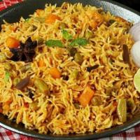Vegetable Biryani · Gluten-free. Basmati rice infused with aromatic spices, veggies & herbs. Served with Raita.