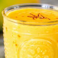 Mango Lassi  (16 Oz) · A sweetened cold drink with a blend of yogurt and mango pulp