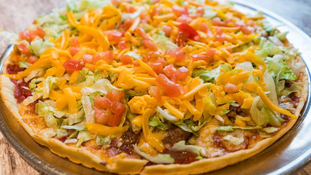Taco Pizza · Seasoned ground beef, chips, lettuce, cheddar cheese, and tomatoes.