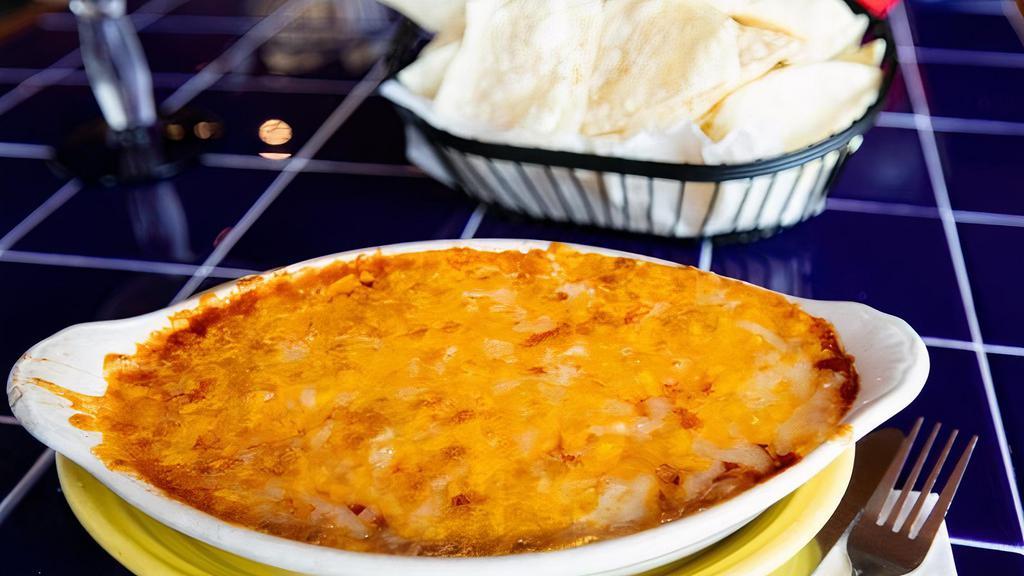 Bean Dip (Frijoles Y Mas) · Layered dip with refried beans, red sauce, onions, and cheese. Served with crisp corn or flour tortilla chips. Add Spicy Chorizo Sausage, Seasoned Taco Beef for an additional charge.