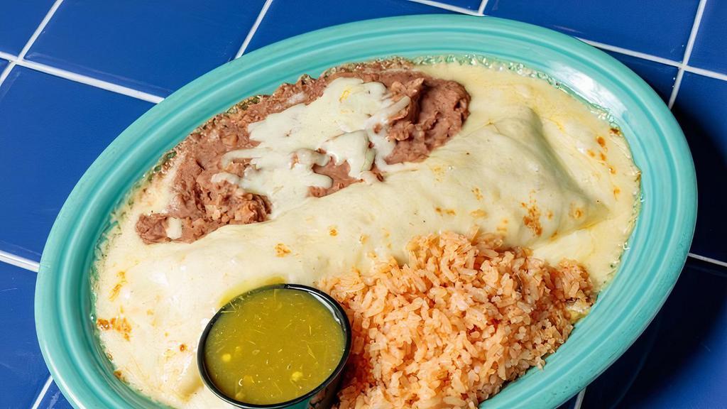 Steak & Chorizo Blanco Style · Marinated fajita steak and spicy chorizo sausage rolled in a flour tortilla with cheddar and jack blend, topped with creamy queso blanco and baked bubbly hot.  Served with rice and beans