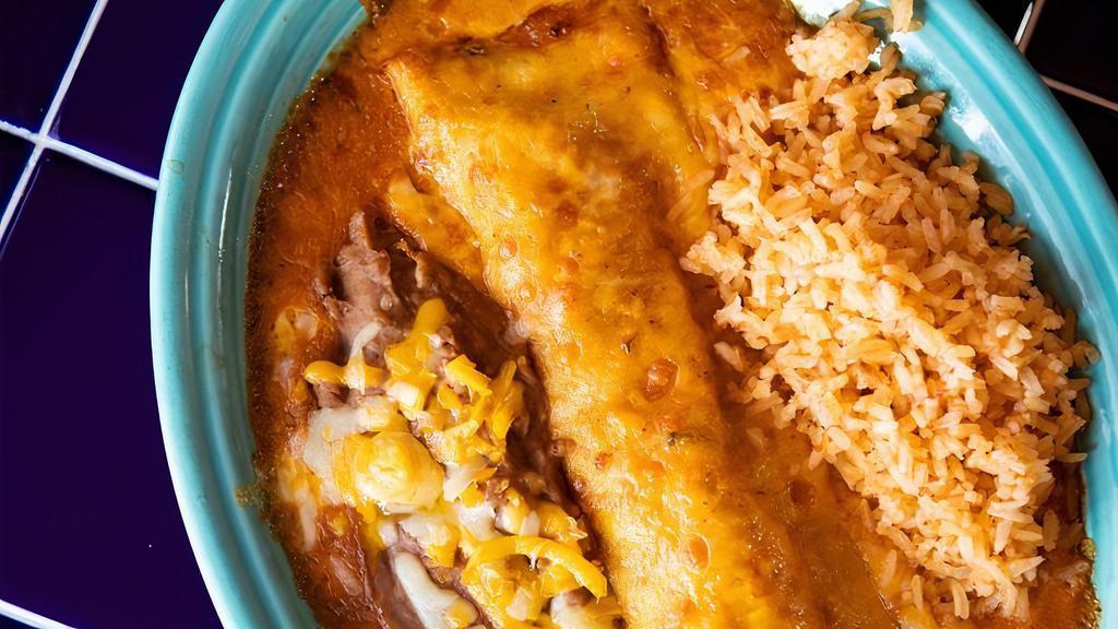 Steak & Chorizo Roja  Enchilada · Marinated fajita steak and spicy chorizo sausage rolled in a flour tortilla  with cheddar/jack blend, topped with enchilada sauce, cheese and baked bubbly hot.  Serves with rice and beans