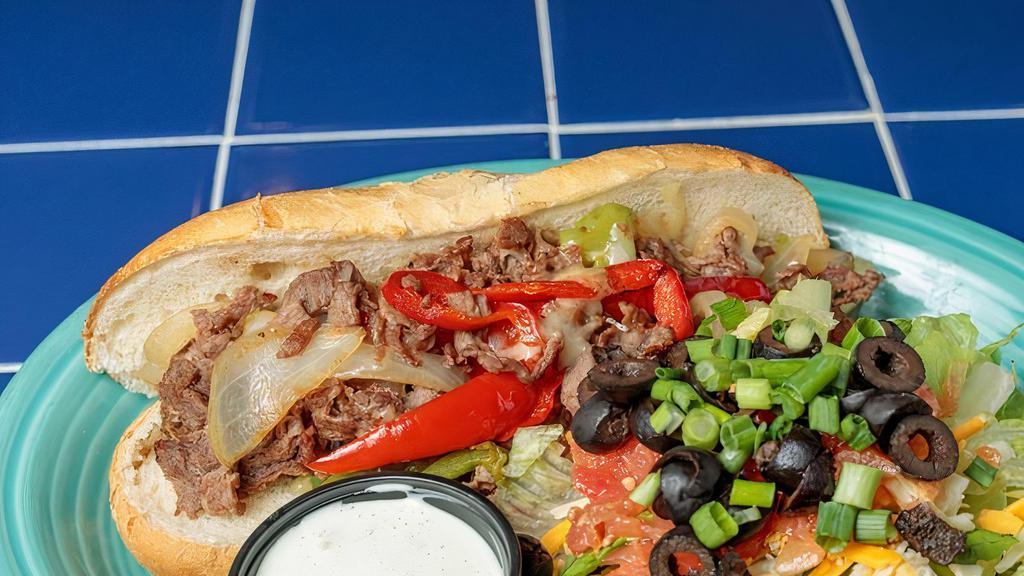 Philly Steak Sandwich · Choice of thinly sliced steak or fajita chicken, grilled with sweet onions, green, and red pepper, topped with choice of creamy jack cheese or queso blanco and served on a locally made soft and chewy rotella hoagie roll. Served with pickles and chips.