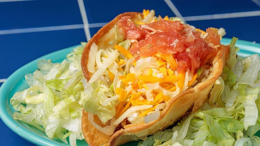 Taco · All Tacos are topped with shredded lettuce, cheese and diced tomatoes.
