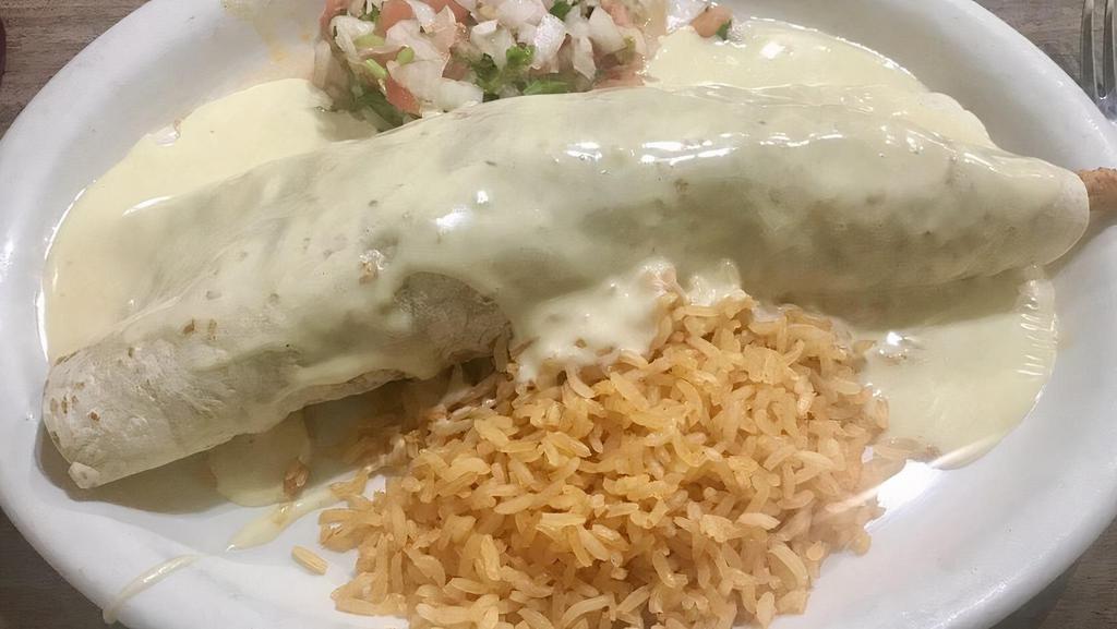 Burrito Loco · chorizo (mexican sausage), grilled steak and grilled chicken sauted with onions, served, with rice  pico de gallo and topped with cheese sauce