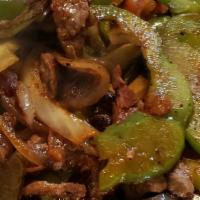 Fajitas · Grilled steak or chicken strips, bell peppers, onions, tomatoes, served with rice, beans, le...