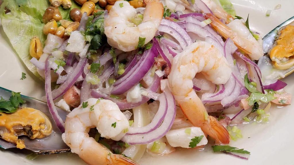 Shrimp Salad · Marinated shrimp with fresh lime juice and jalapeños, with cucumbers, avocado, tomato and orange slices.