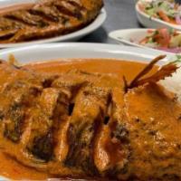 Mojarra Marinera · a fried whole tilapia covered with a creamy spicy homemade sauce, served with criolla salad ...