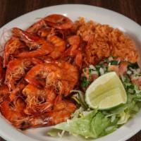 Shrimp Cucaracha-Style · A buttery spicy sauce smothered over a bed of fried shrimp, served with white rice and criol...