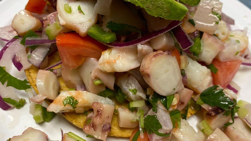 Shrimp Tostadas · Boiled shrimp topped with fresh onions, tomatoes, cilantro, celery, fresh jalapeños and avocados.