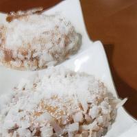Alfajores · 3 cookies filled with dulce de leche, covered with powdered sugar and rolled in coconut flak...