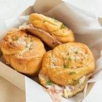 Spicy Ham And Cheese Slider · Ham, Jalapeno, Mozzarella, topped with Garlic butter, Romano, Parsley, and Hot honey.
